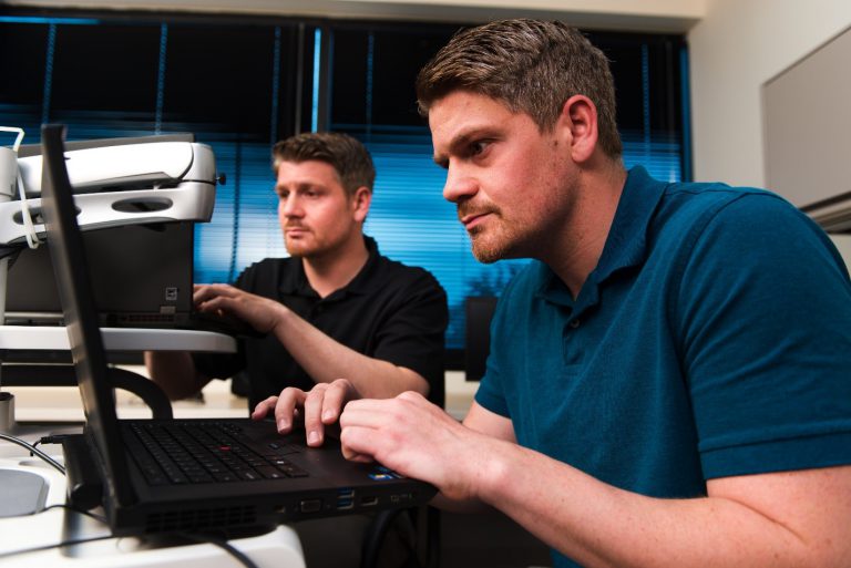 men working on a laptop